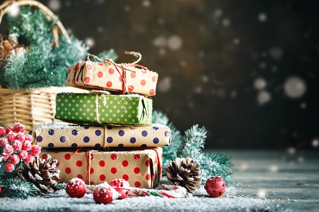 Basket with Christmas toys and Christmas gifts on a wooden background