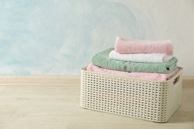 Basket with clean laundry on textured floor,