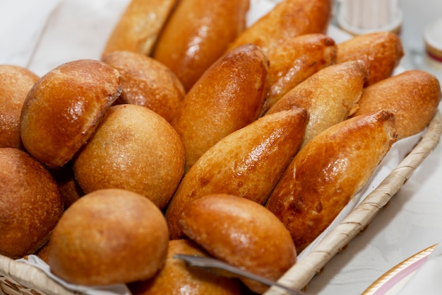 A basket with delicious Russian pies on the table.