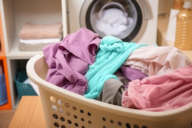 Basket with laundry on table in bathroom