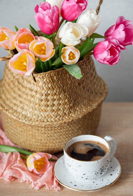 Basket with spring colorful tulips on the table