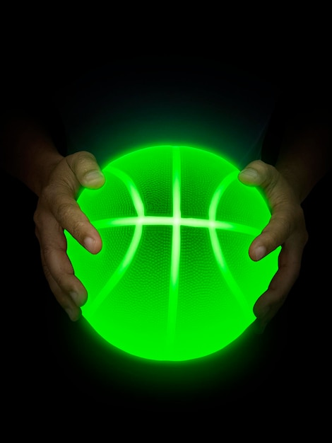 Basketball ball bright green neon lights in male hands