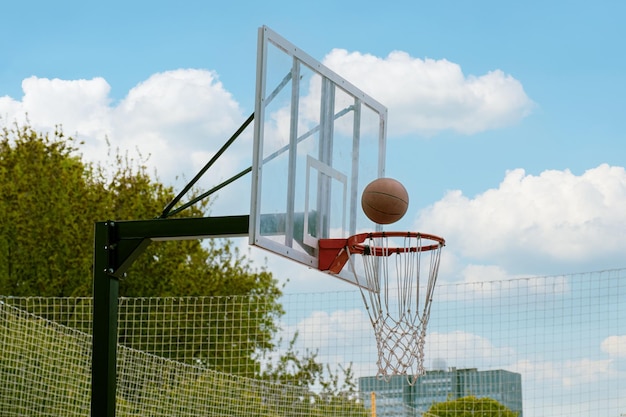 Basketball ball flies into the ring Outdoor sports ground for playing basketball