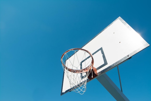 Basketball hoop under a blue sky