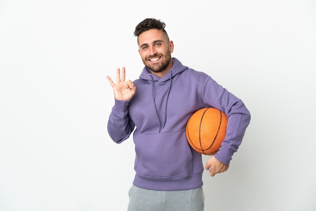 Basketball player man isolated on white background showing ok sign with fingers