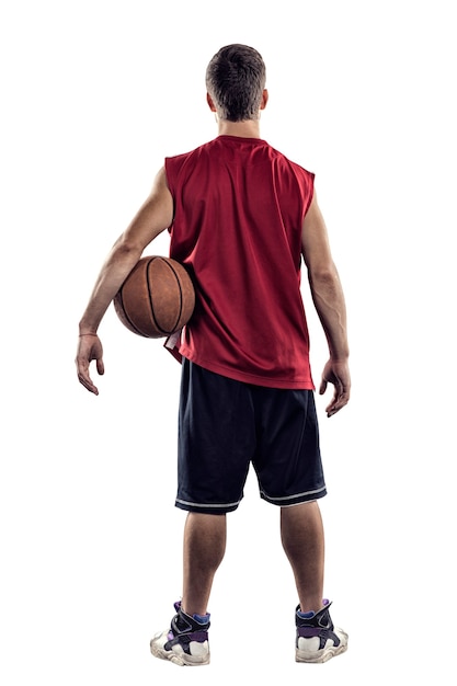 Basketball player standing back to camera with ball in hand isolated on white background