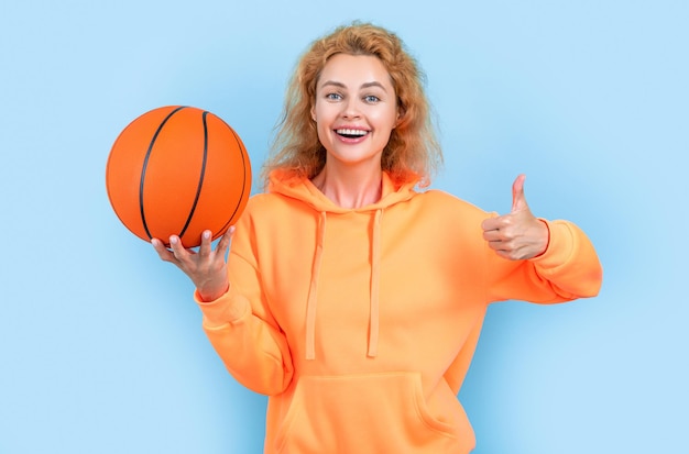 Basketball woman player isolated on blue background thumb up basketball woman player