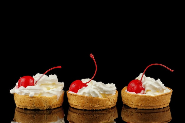 Baskets of pastries with cherry and cream Cake basket with meringue and cherries