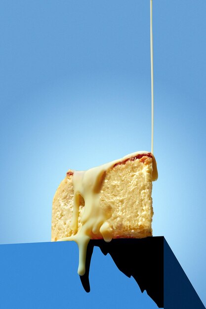 Basque cheesecake poured with sweet sauce on a blue background Minimalist style with space for text