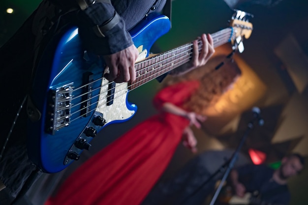 Bass guitar in the hands of a musician