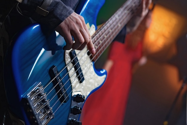 Bass guitar in the hands of a musician