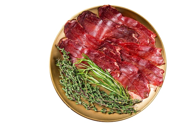 Basturma sliced dried beef meat meat Jerky in steel plate with herbs and spices Isolated on white background