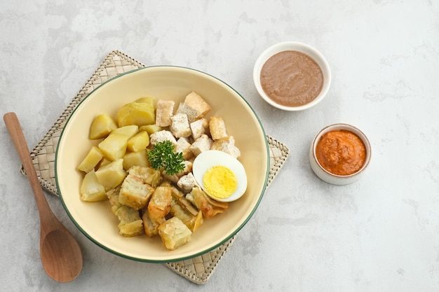 Batagor, Indonesian food made from fried fish dumpling, tofu, egg and potatoes with peanut sauce.