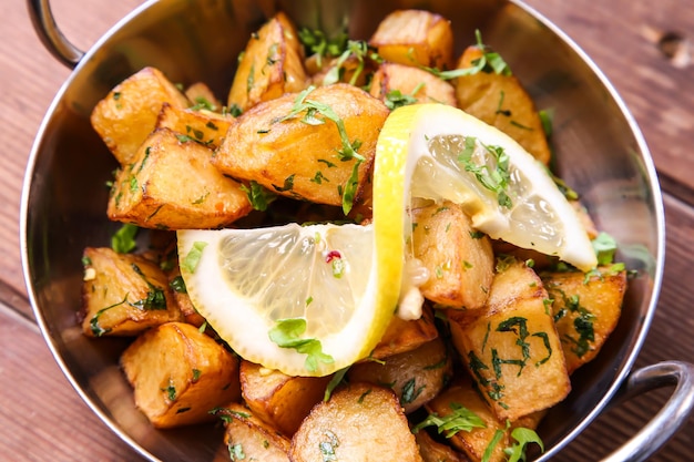 Batata Harra or lebanese spicy potatoes with lemon served in dish isolated on background top view of hot mezza