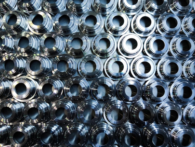 A batch of shiny metal cnc aerospace parts production closeup flat lay with selective focus for industrial background