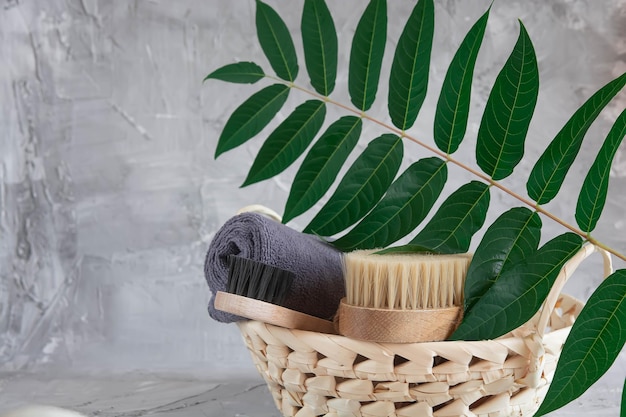 Bath accessories on a gray background, penza, brush, basket and flowers