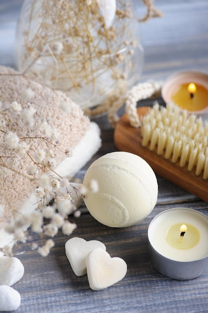 Bath bombs with dry flowers and lit candles