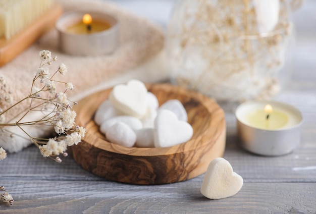 Bath bombs with dry flowers and lit candles