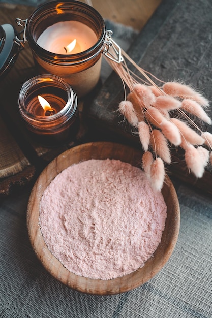 Bath powder in wooden bowl and candles care and relaxation concept