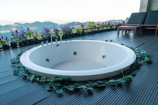 bath tub on balcony with mountain hill background