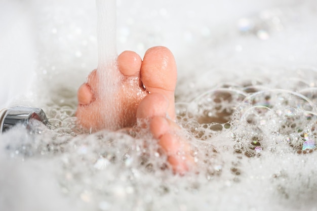 Bathing in a bathtub with white foam