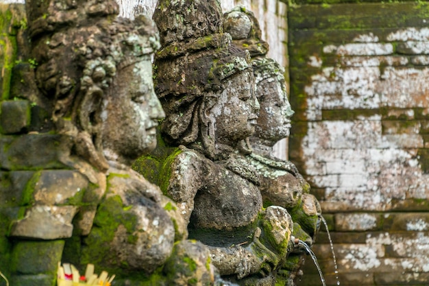 Bathing Temple traditional figures in Goa Gajah Temple Elephant Cave on Bali Indonesia