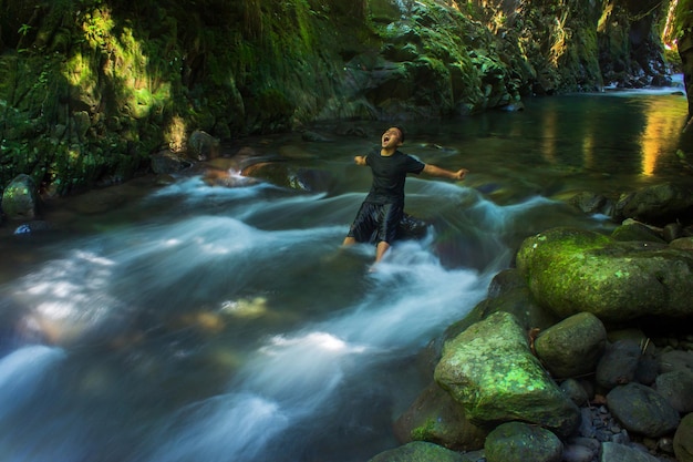 Bathing in the water aisle in the tropical forest of Indonesia