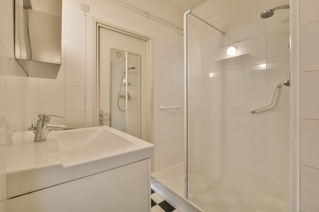 Bathroom interior in white tones and tiles on the floor in the form of chess with shower and sink