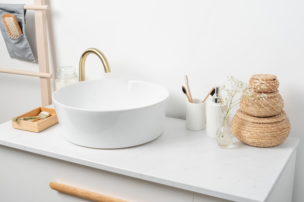 Bathroom marble counter with sink candles and toothbrushes near white wall copy space