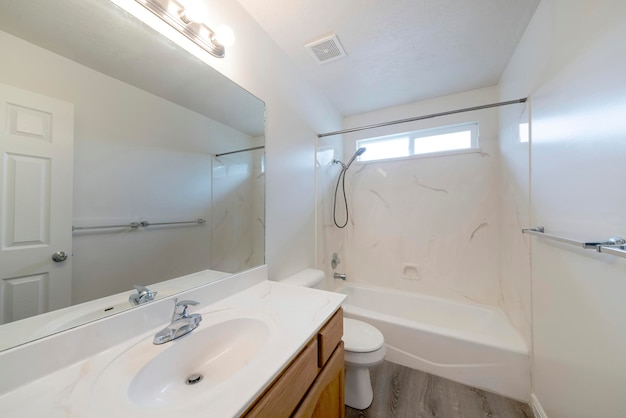 Bathroom of a modern apartment with white furniture