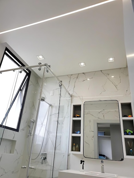 a bathroom with a large mirror and a glass door