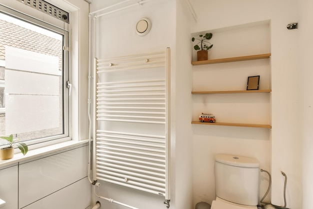 a bathroom with shelves on the wall and a toilet in the corner next to the window that is open