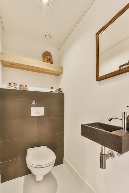 a bathroom with a sink mirror and toilet paper dispensed on the wall next to the toilet