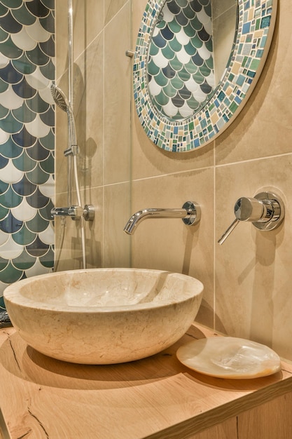 A bathroom with a sink and shower and a mirror