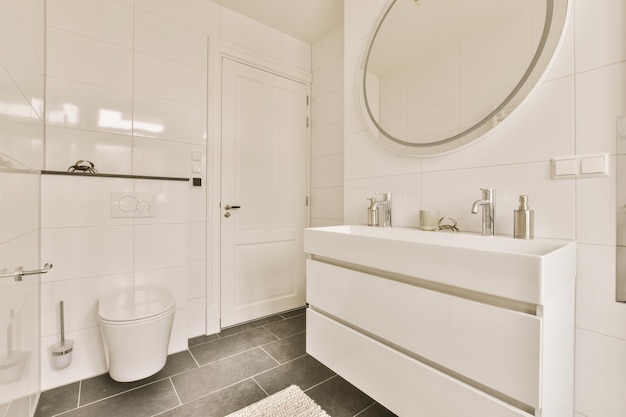 A bathroom with a toilet sink and a mirror