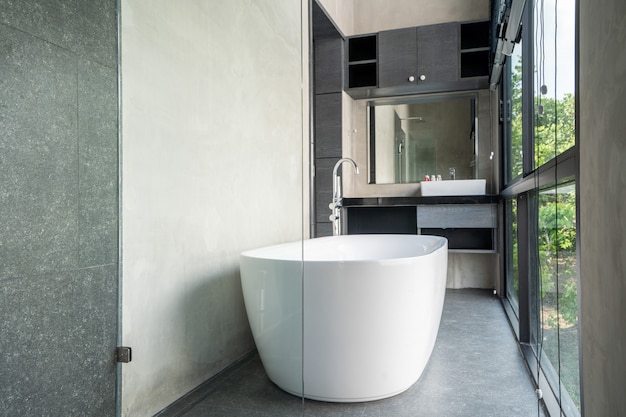 Bathtub in modern loft villa with open space window glass