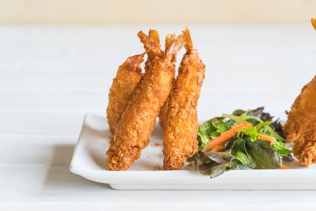  batter-fried prawns on wood