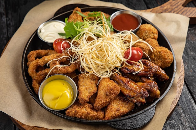 battered seafood in a pan on a black background