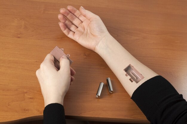 Batteries inserted into a hand.