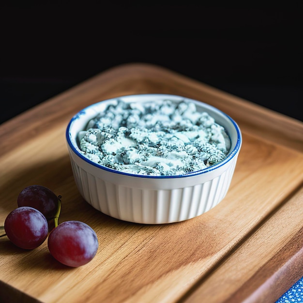 Bavaria blue cheese with grapes on board close up