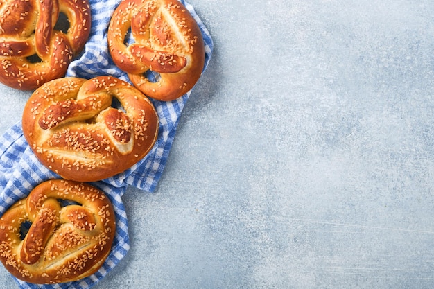 Bavarian pretzels and glass of lager beer Oktoberfest food menu traditional salted pretzels on light grey background Top view with space for text Oktoberfest theme