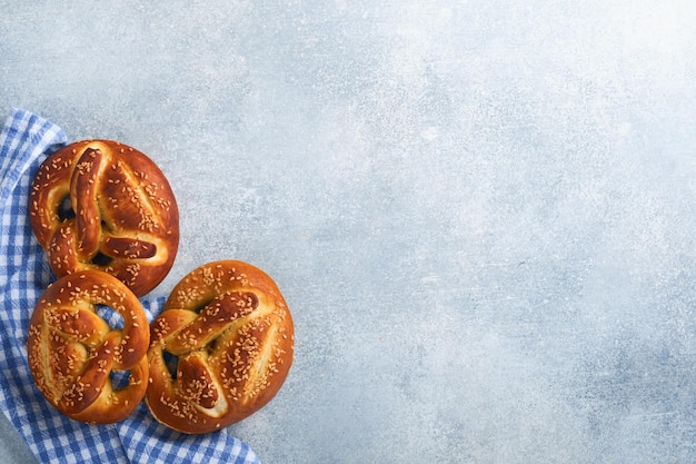 Bavarian pretzels and glass of lager beer Oktoberfest food menu traditional salted pretzels on light grey background Top view with space for text Oktoberfest theme