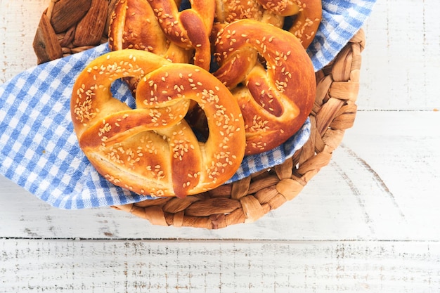 Bavarian pretzels and glass of lager beer Oktoberfest food menu traditional salted pretzels over old white wooden background Top view with space for text Oktoberfest theme