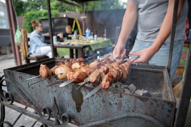 BBQ picnic with kebabs and meat on an open fire on a summer day in the backyard of a private house