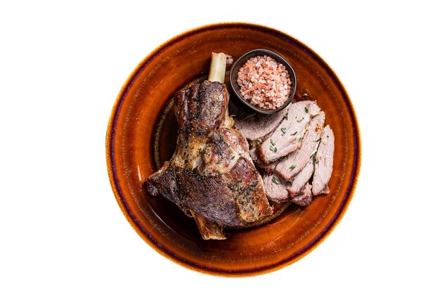 BBQ Roast Lamb mutton leg sliced on a rustic plate Isolated on white background