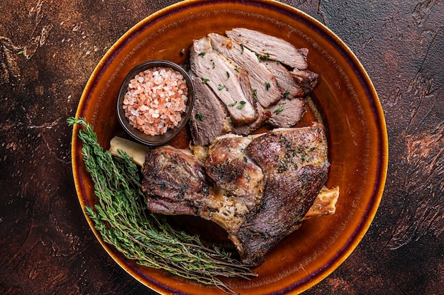 BBQ Roast Lamb mutton leg sliced on a rustic plate