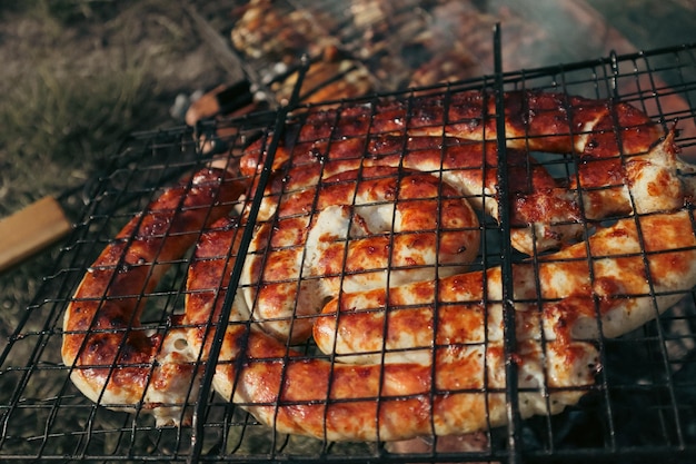 BBQ spiral sausage from pork and beef meat on a grill Delicious grilled sausage