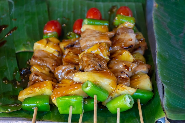 BBQ sticks grilling on fire with smoke