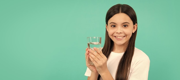 Be hydrated kid hold glass of water child feel thirsty teen girl going to drink mineral beverage Banner of child girl with glass of water studio portrait with copy space