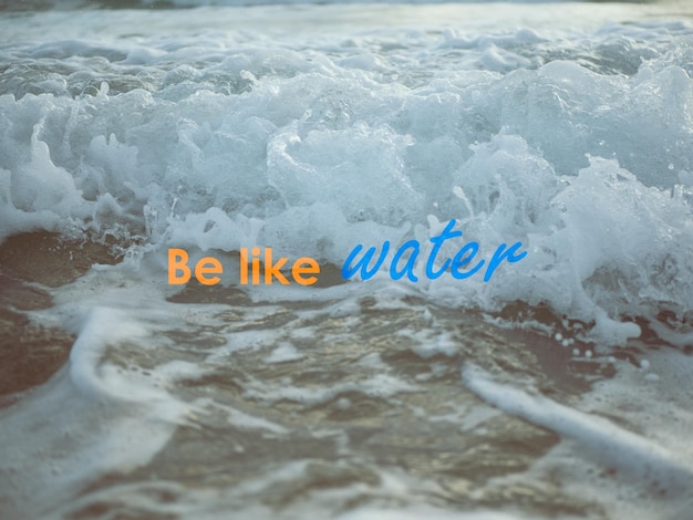 Be like water quote on an ocean wave background